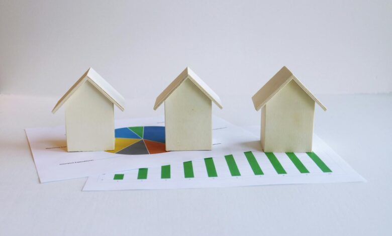 three small houses sitting on top of a piece of paper